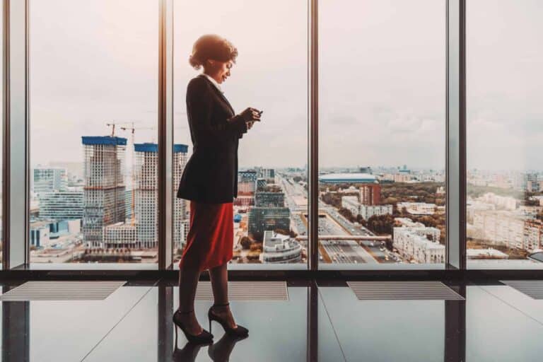 A woman in front of an office window