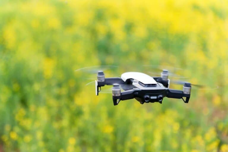 Modern dark and red drone in the air in mountains close